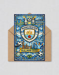 May include: A greeting card with a stained glass design featuring the Manchester City Football Club logo, the words "Manchester" and "Blue Moon Rising", and illustrations of the Etihad Stadium and other landmarks. The card is inside a brown envelope.