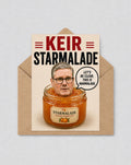 May include: A humorous greeting card with the words "KEIR STARMALADE" in red and black. The image depicts a man's head in a jar of orange marmalade, with a speech bubble stating "LET'S BE CLEAR, THIS IS MARMALADE."