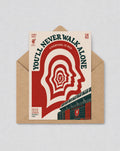 May include: A cream-coloured card with a red and white graphic, inside a brown envelope. The design features the text "YOU'LL NEVER WALK ALONE" and "LIVERPOOL IS RED", with head silhouettes. The Liverpool FC logo is also visible.