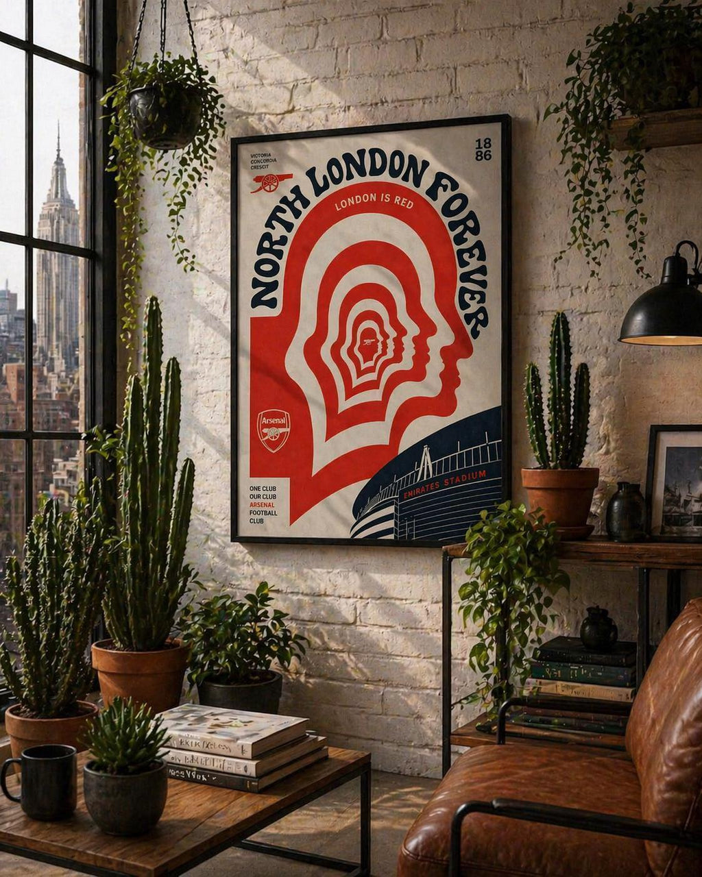 May include: Framed poster with the text "NORTH LONDON FOREVER" in red and white. The design includes a head silhouette and the Arsenal logo. The background is a brick wall with plants and a leather armchair, creating a cozy atmosphere.